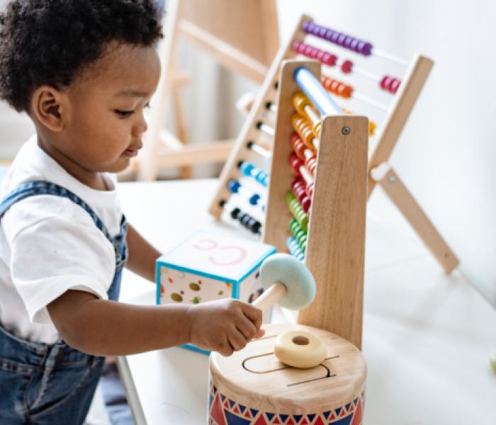 Young child playing with toys image