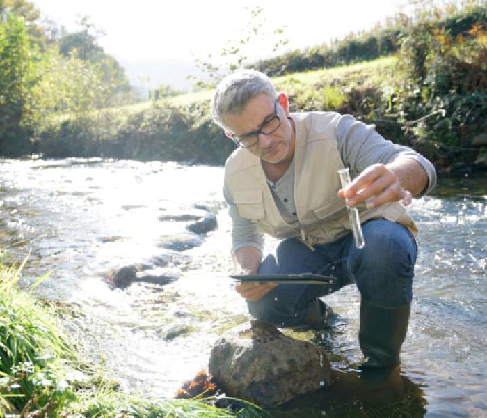 Man testing water in a creek image