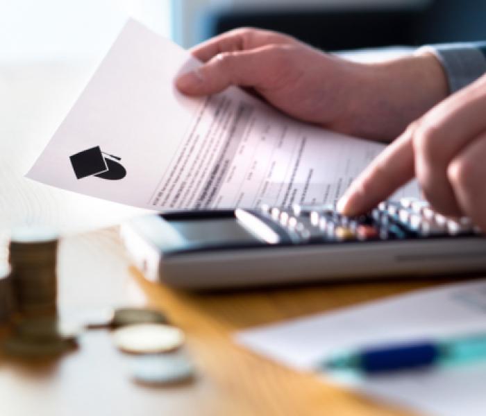 Person using a calculator and holding paper image