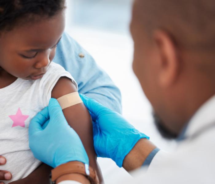 Doctor applying a bandage to a child's arm image