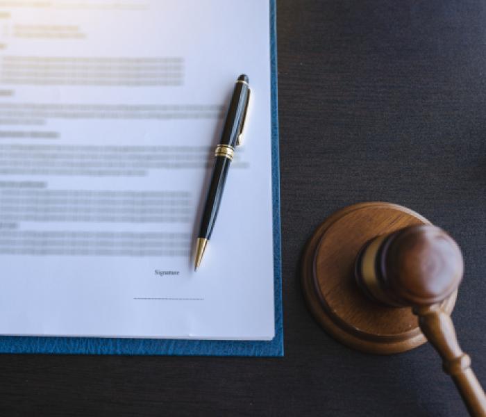 Pen atop a legal document next to a gavel