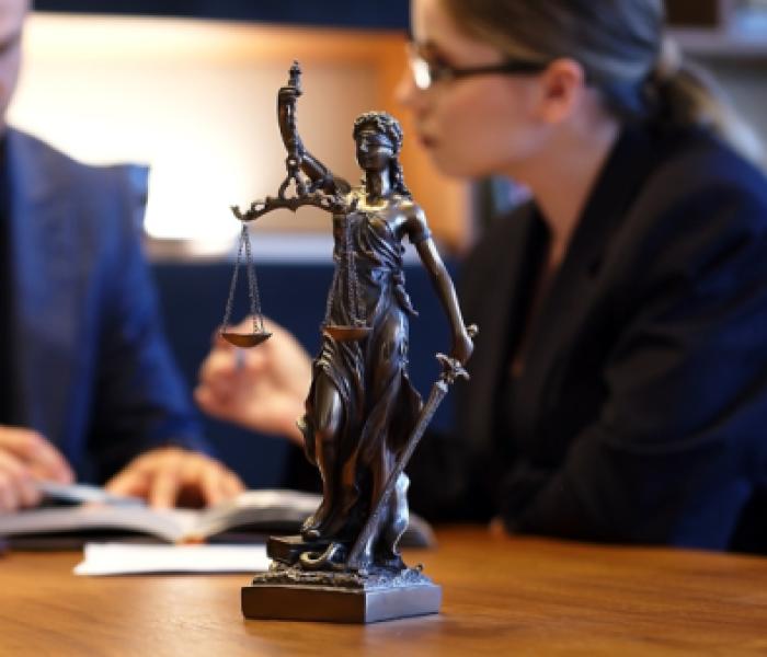 Two people sitting at a law desk image