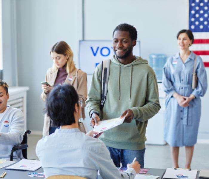 people checking in at a polling station